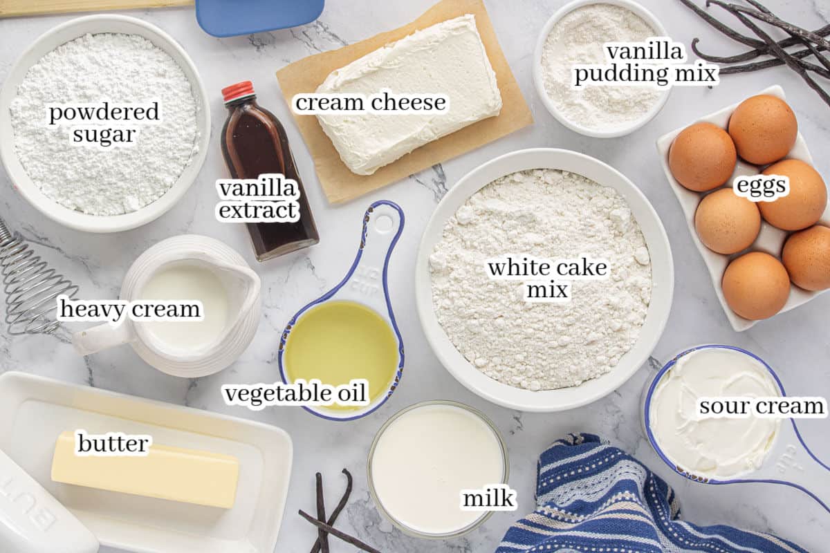 Ingredients for vanilla Bundt cake including white cake mix, vanilla pudding mix, eggs, sour cream, milk, oil, vanilla, butter, cream cheese, heavy cream, and powdered sugar.