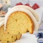 Close-up of a vanilla Bundt cake slice showing the soft crumb and thick cream cheese frosting.