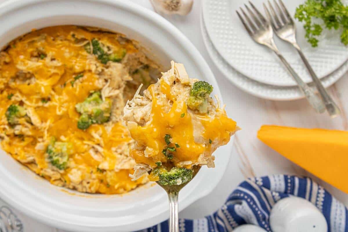 Cheesy Crockpot Chicken and Rice with Broccoli served from the slow cooker with tender chicken, broccoli, and melted cheddar cheese.