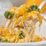 Spoonful of Crockpot Chicken and Rice with Broccoli with shredded chicken, creamy rice, broccoli, and melted cheddar cheese.